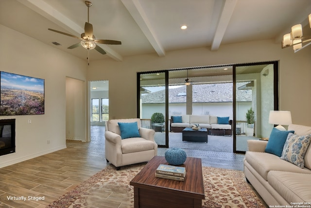 living room featuring beamed ceiling, light hardwood / wood-style flooring, and ceiling fan