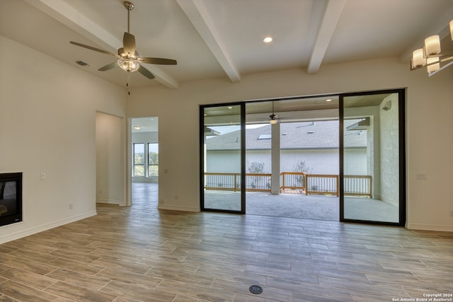 spare room featuring beam ceiling, ceiling fan, and light hardwood / wood-style flooring