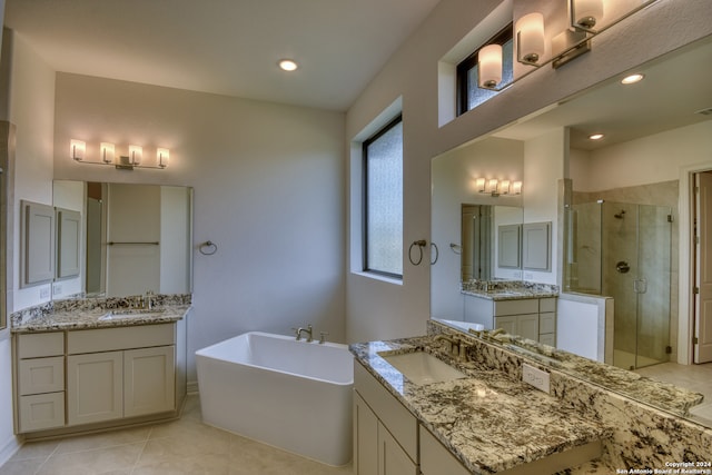 bathroom featuring tile patterned flooring, vanity, and shower with separate bathtub