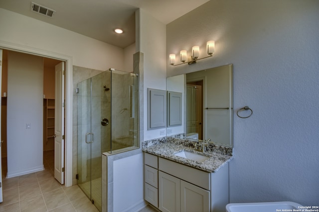 bathroom with tile patterned flooring, vanity, and an enclosed shower