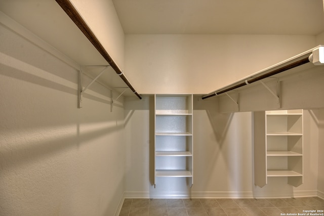 walk in closet with light tile patterned floors