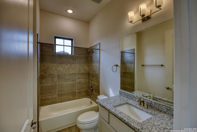 full bathroom featuring toilet, vanity, and tiled shower / bath