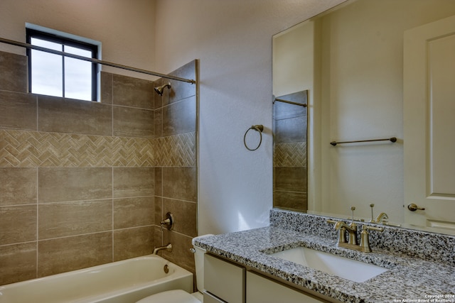 full bathroom featuring vanity, toilet, and tiled shower / bath