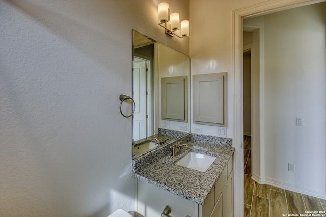 bathroom with vanity and wood-type flooring