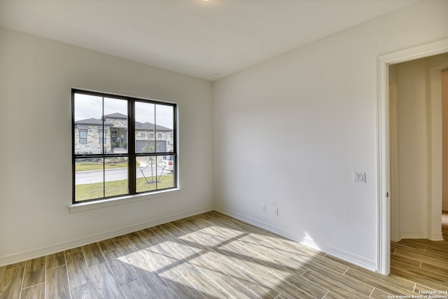 empty room with light hardwood / wood-style flooring