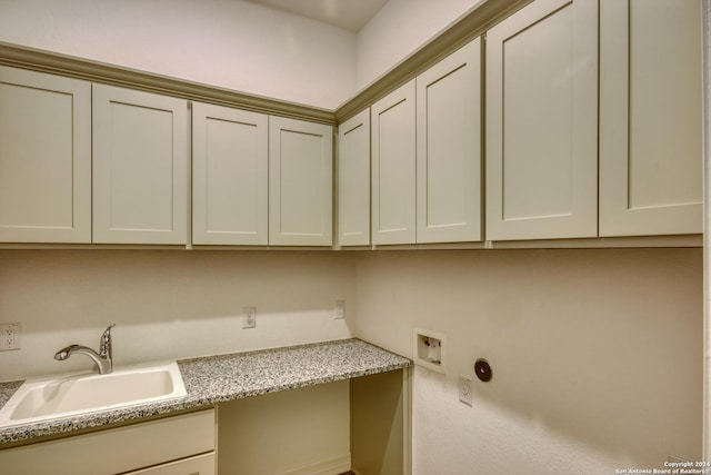 laundry room featuring hookup for a washing machine, sink, and cabinets