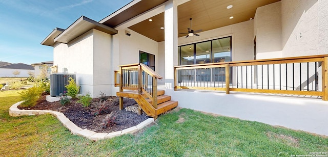 exterior space with a yard, ceiling fan, and central air condition unit