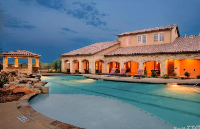 exterior space featuring a gazebo, a patio area, and a community pool