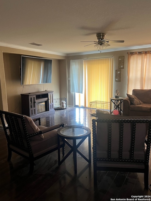 living room featuring ceiling fan, dark hardwood / wood-style flooring, and ornamental molding