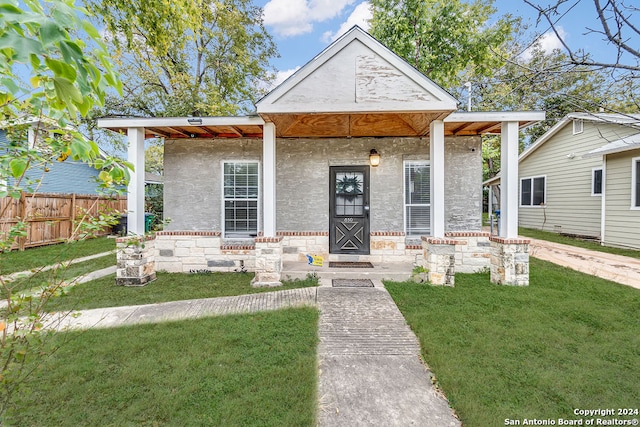 view of front of home with a porch and a front yard