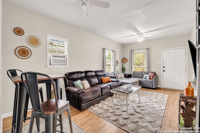 living room featuring ceiling fan, light hardwood / wood-style flooring, and cooling unit