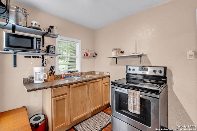 830 Canton, San Antonio, TX 78202 - kitchen with stainless steel appliances, open shelves, a sink, dark countertops, and light brown cabinets