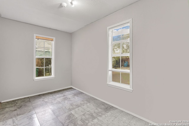 unfurnished room featuring a textured ceiling