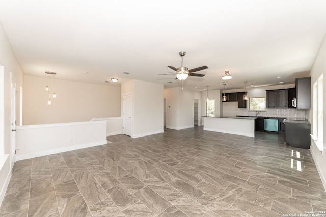 unfurnished living room featuring ceiling fan