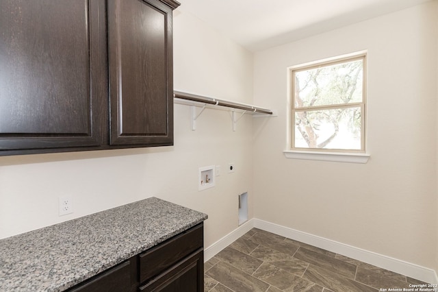 washroom with hookup for a washing machine, cabinets, and hookup for an electric dryer