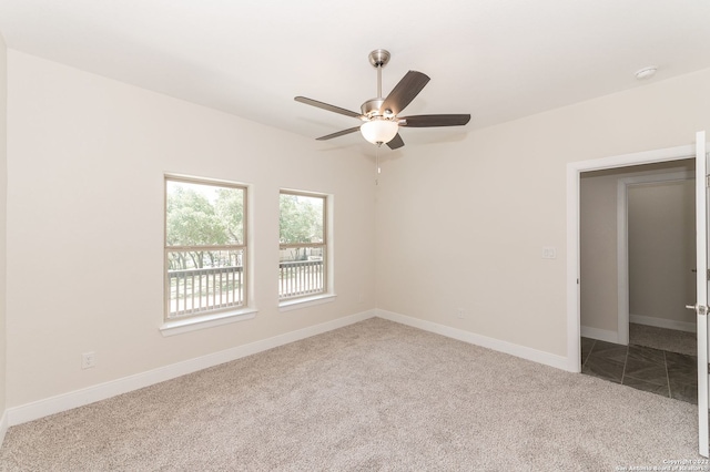 carpeted empty room with ceiling fan