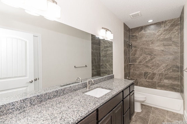 full bathroom featuring vanity, toilet, and tiled shower / bath