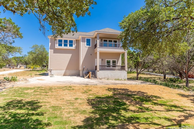 back of property featuring a balcony