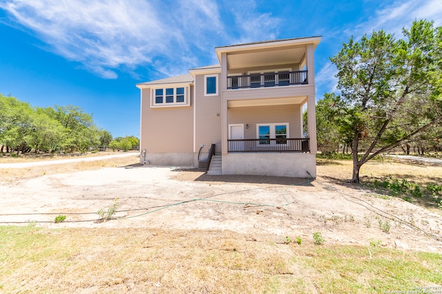 rear view of house featuring a balcony