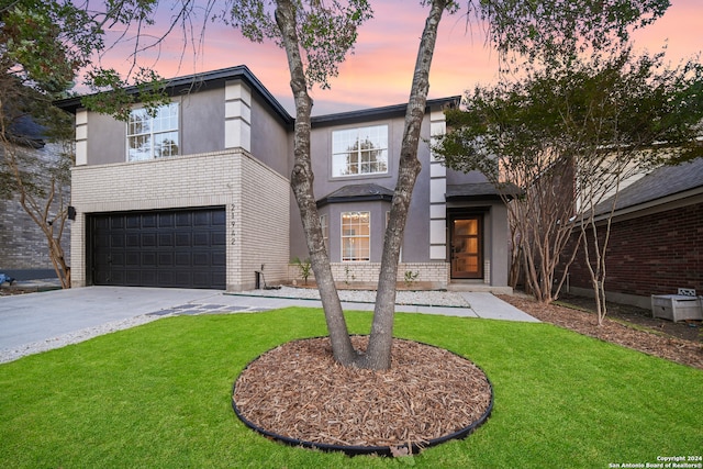 view of front facade featuring a lawn and a garage