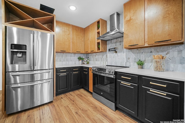 kitchen with decorative backsplash, light wood-type flooring, wall chimney range hood, and appliances with stainless steel finishes