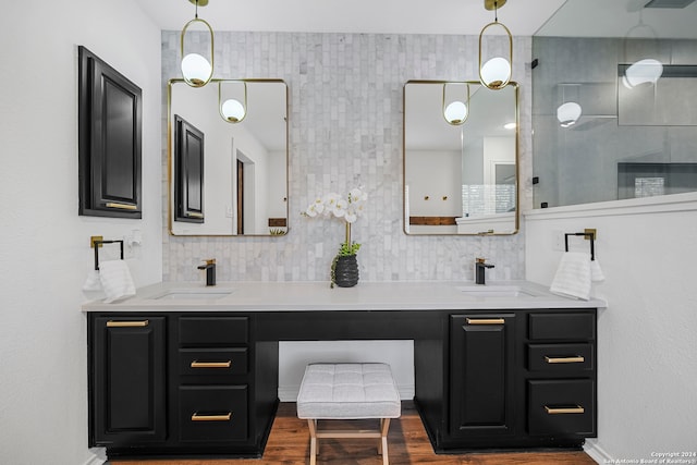 bathroom with backsplash, vanity, and hardwood / wood-style flooring