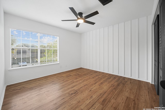 spare room featuring ceiling fan and hardwood / wood-style floors