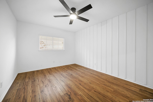 spare room featuring hardwood / wood-style floors and ceiling fan