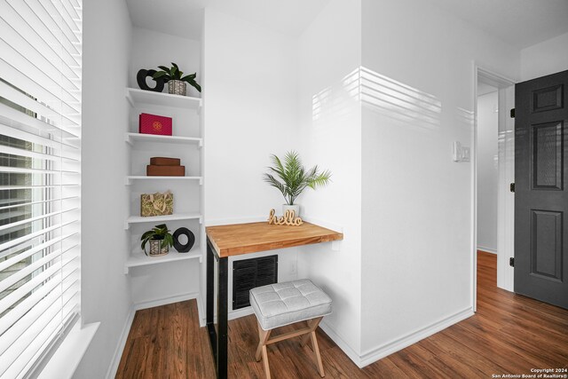 corridor featuring dark hardwood / wood-style flooring and a wealth of natural light