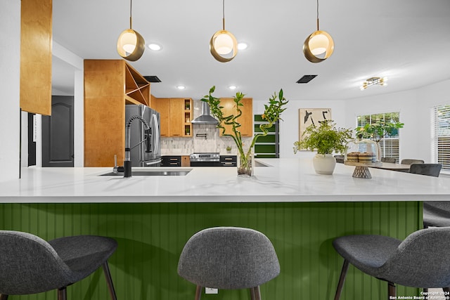 kitchen featuring kitchen peninsula, pendant lighting, and backsplash