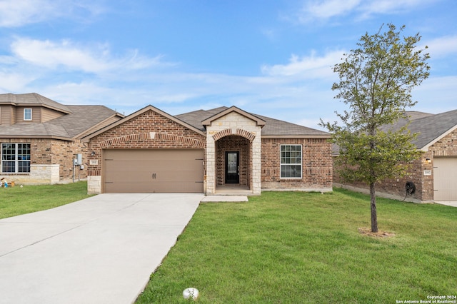 view of front of home with a garage and a front yard