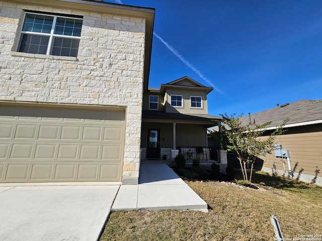 view of front of house featuring a porch and a garage