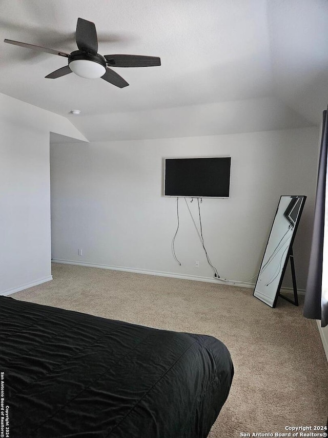 carpeted bedroom with ceiling fan and lofted ceiling