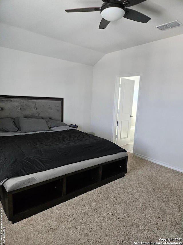 carpeted bedroom featuring ensuite bathroom, ceiling fan, and lofted ceiling