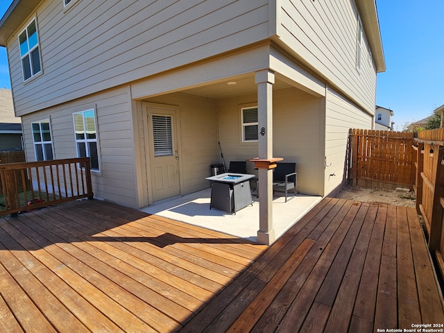 wooden deck featuring a patio area and an outdoor fire pit