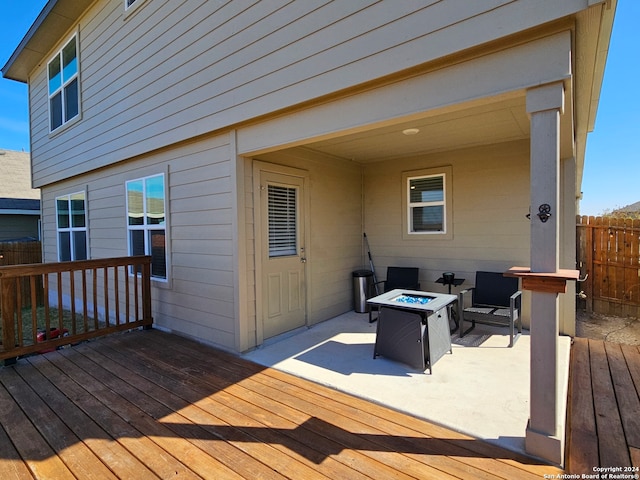 wooden deck featuring an outdoor fire pit