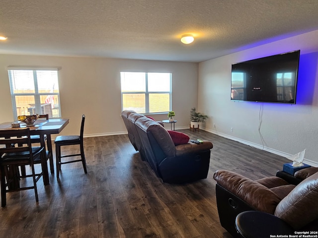 living room featuring a textured ceiling and dark wood-type flooring