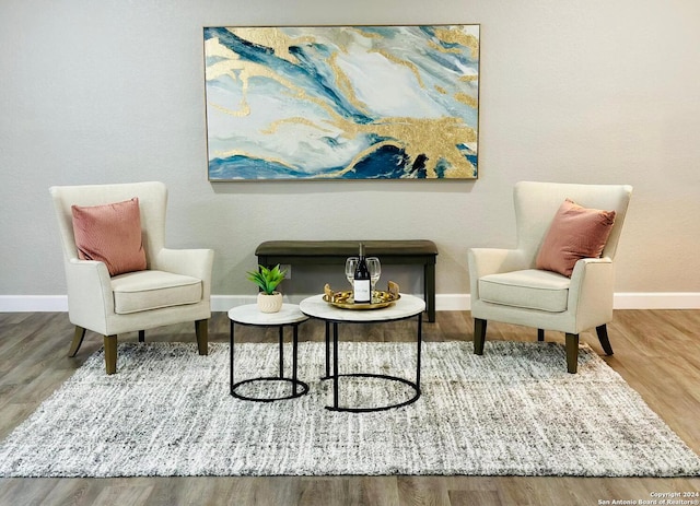 sitting room with hardwood / wood-style flooring