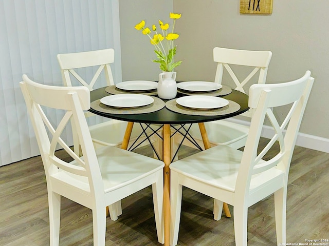 dining space with hardwood / wood-style flooring