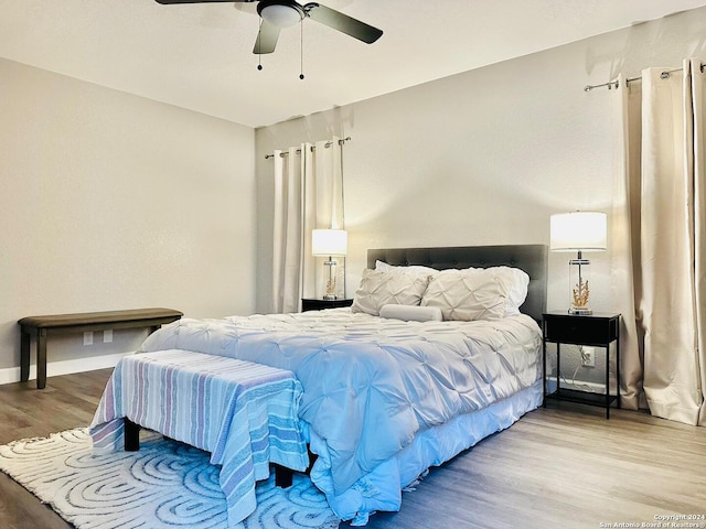 bedroom with ceiling fan and hardwood / wood-style floors