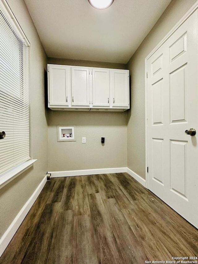 laundry area featuring dark hardwood / wood-style flooring, hookup for a washing machine, cabinets, and hookup for an electric dryer