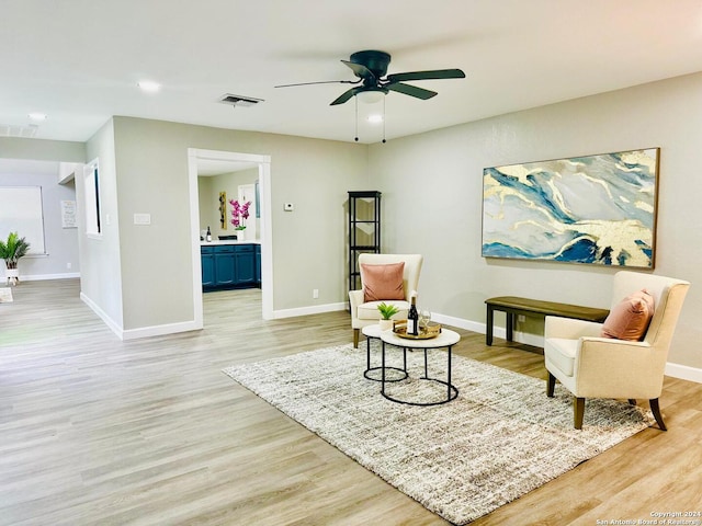 living area featuring ceiling fan and light hardwood / wood-style flooring