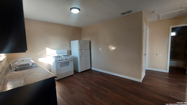 kitchen featuring dark hardwood / wood-style floors, white appliances, and sink