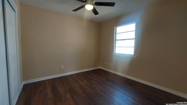 unfurnished room featuring ceiling fan and dark wood-type flooring