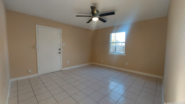 empty room featuring light tile patterned floors and ceiling fan