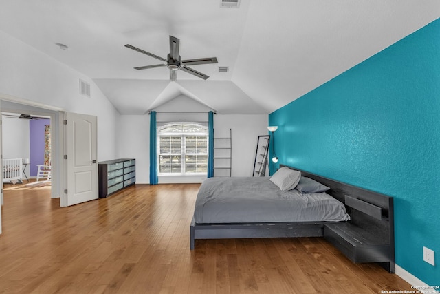 bedroom with hardwood / wood-style floors, ceiling fan, and lofted ceiling