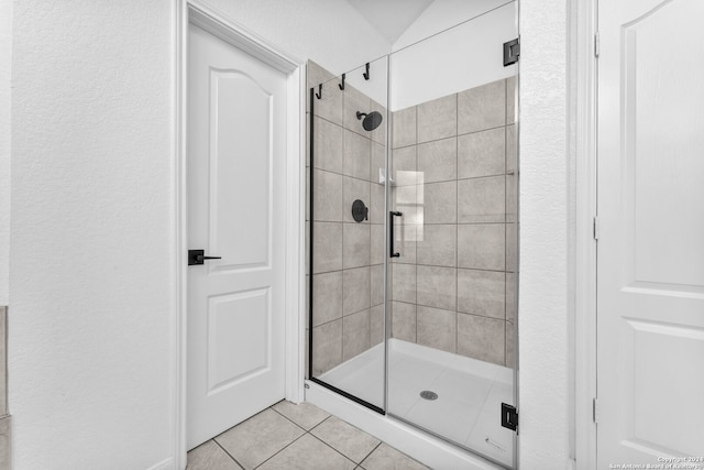 bathroom with tile patterned flooring and walk in shower