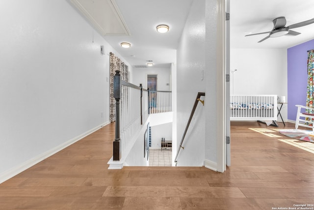 hallway with light hardwood / wood-style floors