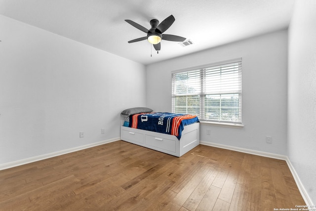 unfurnished bedroom with hardwood / wood-style floors and ceiling fan