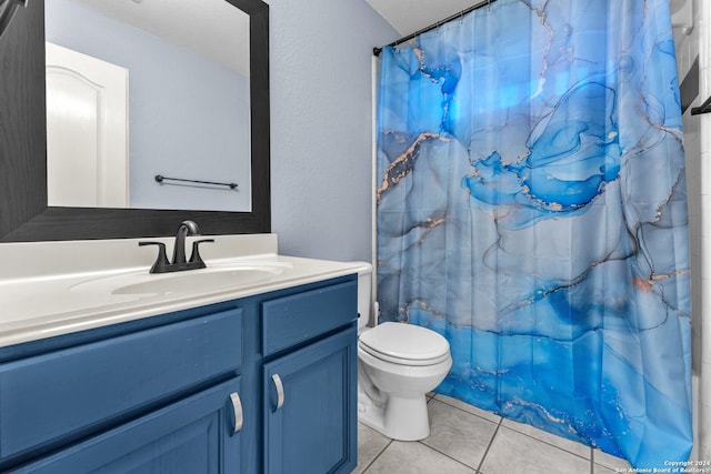 full bathroom featuring tile patterned flooring, shower / tub combo, vanity, and toilet